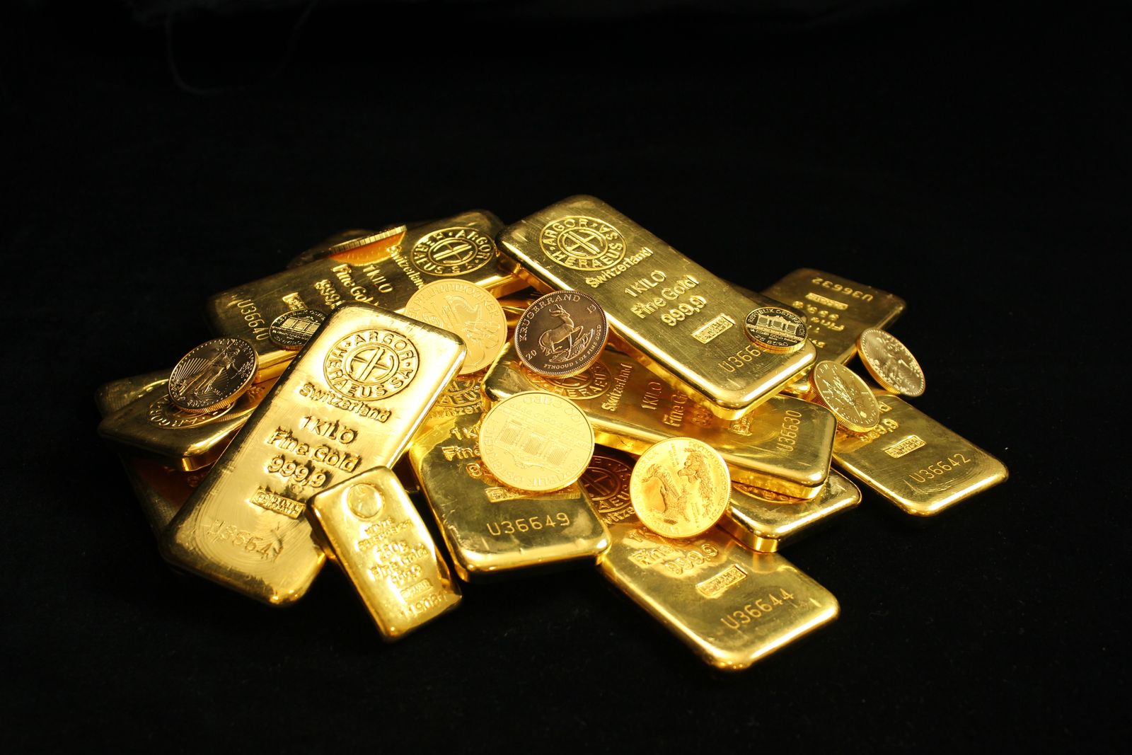 A close-up of gold bars and coins
